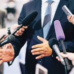 a group of people holding microphones